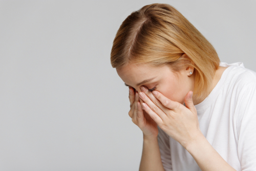 Young woman suffering from dry eyes