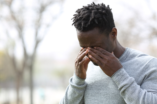 Young man suffering from dry eyes