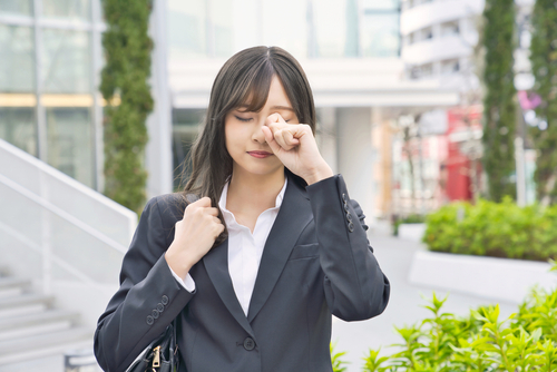 Woman wiping her eyes