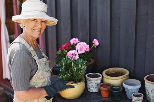 Smiling older woman gardening