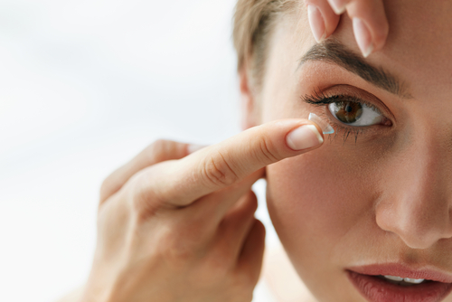 Young woman using contact lenses